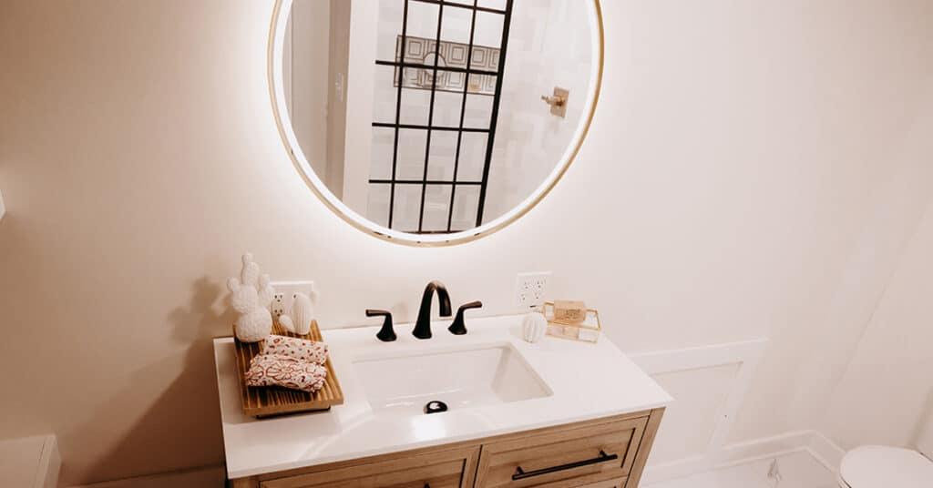 7 Signs it's time to remodel your bathroom - vanity bathroom sink with beautiful shower in the mirror