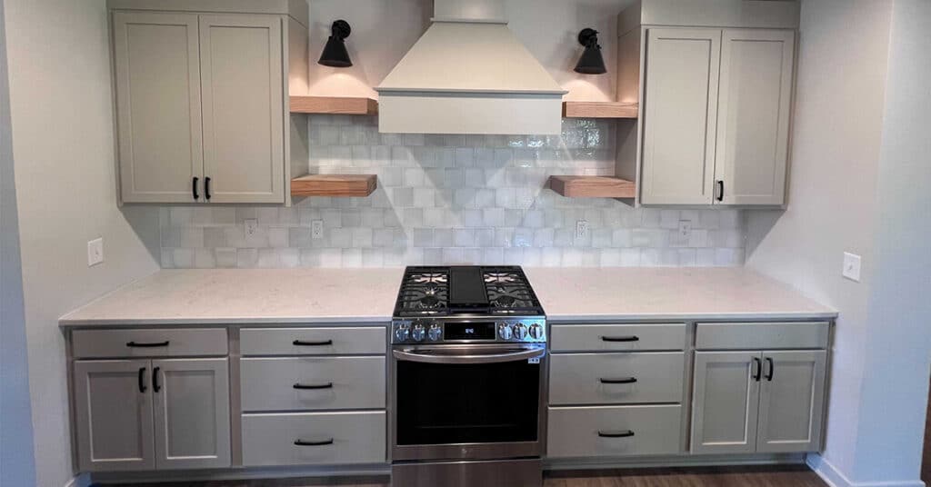Westfield kitchen remodel - light green cabinets with with white tile and black appliances