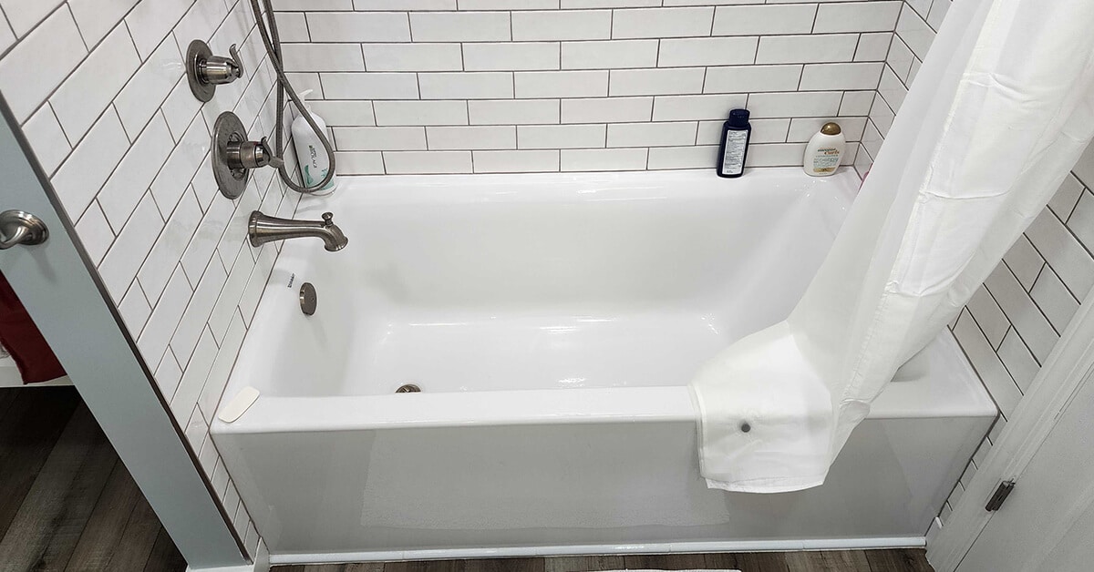 Shower or tub - white bath tub with white subway tile